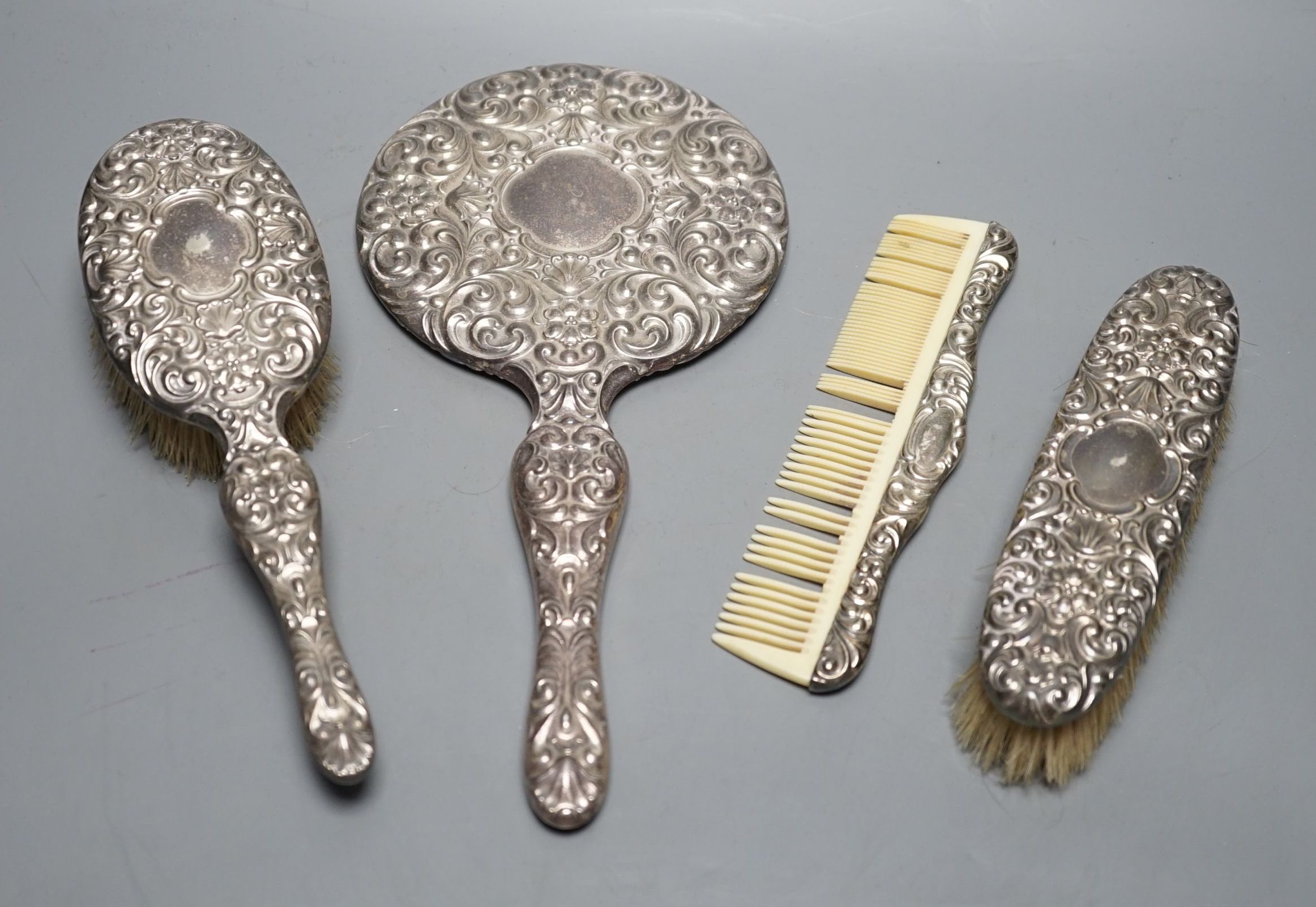 A continental 800 standard white metal mounted four piece mirror and brush set.